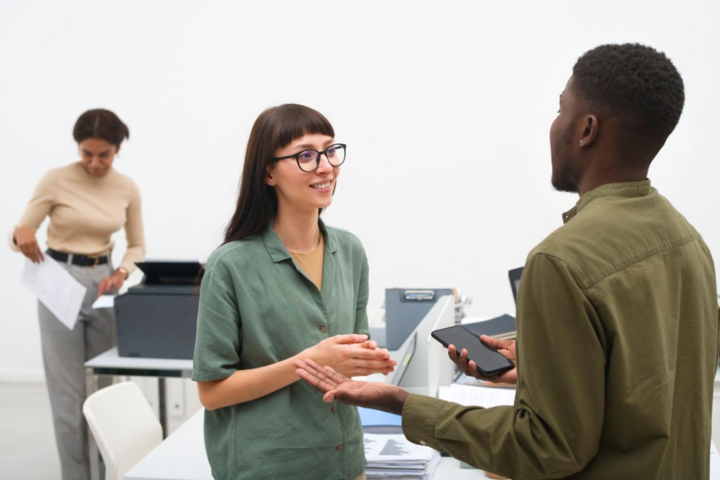 Professional meeting room with presentation screens showing financial charts and growth metrics